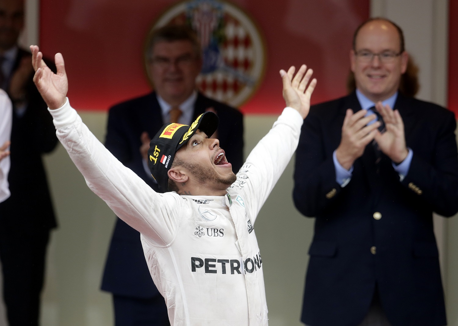 Mercedes driver Lewis Hamilton of Britain celebrates on the podium after winning the Monaco Formula One Grand Prix in Monaco, Sunday, May 29, 2016. (AP Photo/Petr David Josek)