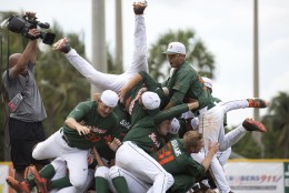 Miami Hurricane players celebrate after a super regional game of the NCAA college baseball tournament against VCU, Saturday, June 6, 2015, in Coral Gables, Fla.Miami won 10-3. (AP Photo/J Pat Carter)