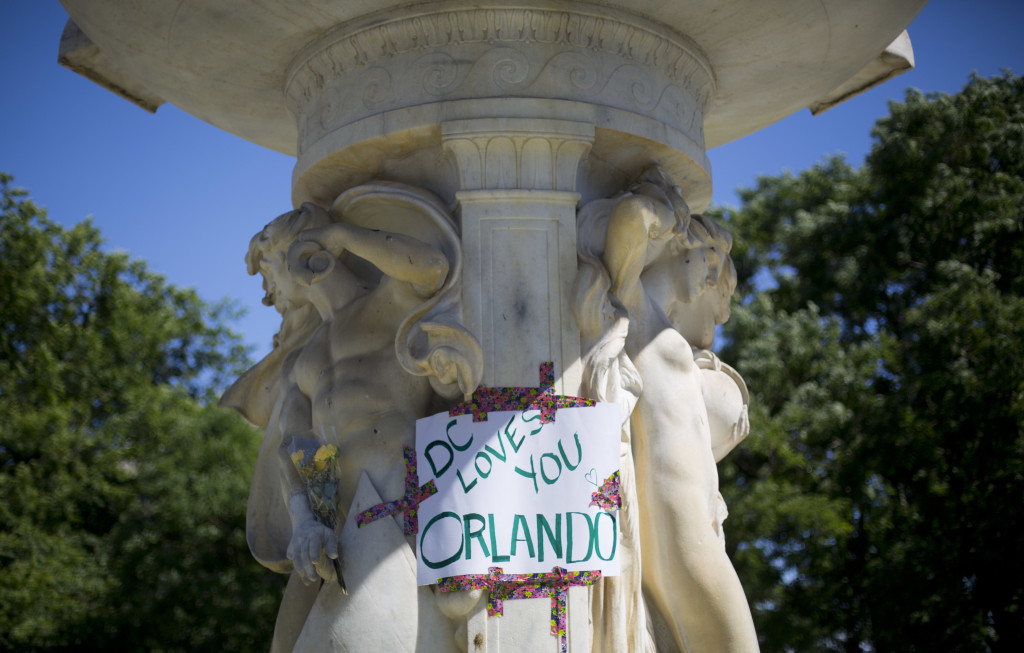 A sign is posted on the fountain at Dupont Circle in support of the victims of the massacre at a Orlando nightclub, after LGBT pride festival organizers held a moment of silence for shooting victims, Sunday, June 12, 2016 in Washington. Local law enforcement officials are beefing up security for Sunday's Capital Pride Festival in D.C. Officials said the shooting at the Orlando nightclub was the worst mass shooting in American history. (AP Photo/Pablo Martinez Monsivais)