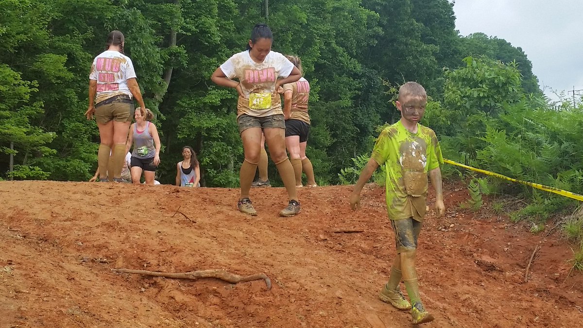 Just a muddy mess, but fun, during the 2016 Run Amuck at Quantico. This is probably the only time this boy's mom won't get mad at him. (WTOP/Kathy Stwart)