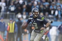 Seattle Seahawks quarterback Russell Wilson (3) runs out of the pocket against the Carolina Panthers during the second half of an NFL divisional playoff football game, Sunday, Jan. 17, 2016, in Charlotte, N.C. (AP Photo/Bob Leverone)