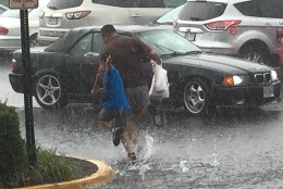People run to their vehicles in Falls Church, Virginia during storms on June 21, 2016. (Courtesy Larry Rubenstein)