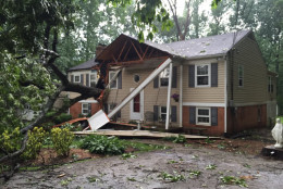 A tree sliced through a home on Burntwoods Road in Glenelg, Maryland, during storms Tuesday. The homeowner's children were home at the time, but both are safe. (WTOP/Michelle Basch)