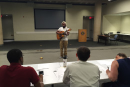 Musician Orin Richards playing guitar and singing songs by Bob Marley and John Legend during his MetroPerforms! audition. (WTOP/Michelle Basch)