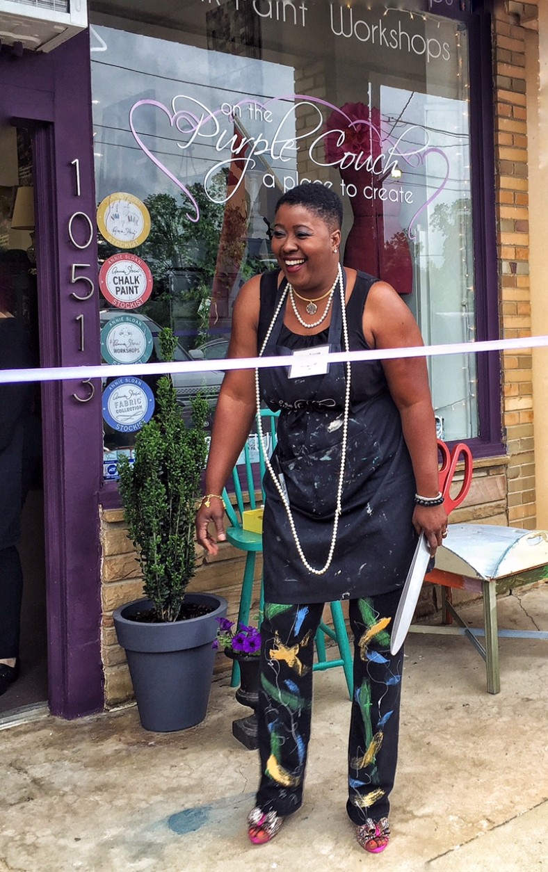 Just before the ribbon-cutting at the  grand opening of her Metropolitan Avenue shop, she shares a laugh with friends. (Kate Ryan/WTOP)