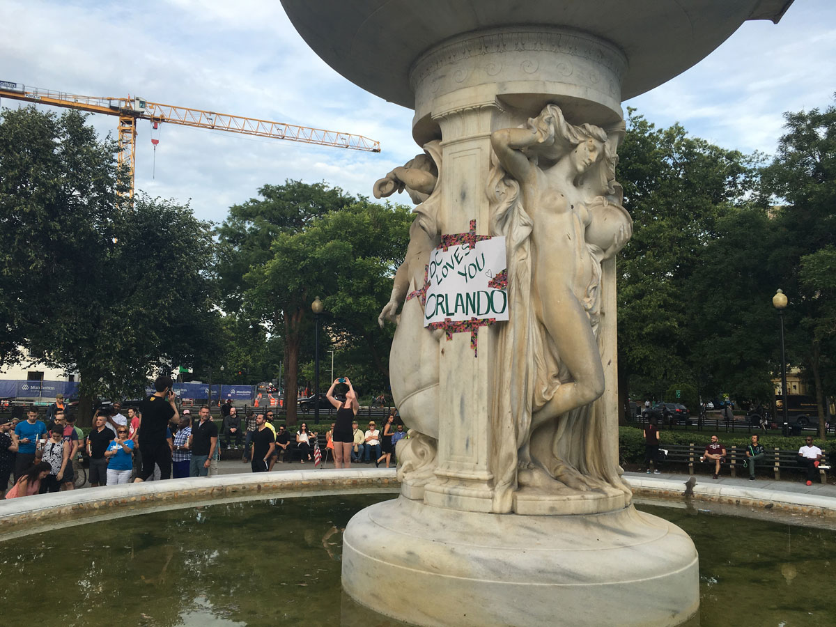 A poster that reads "DC loves you Orlando" has been taped to the fountain at Dupont Circle. (WTOP/Mike Murillo)