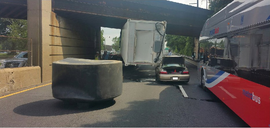 D.C. police tweeted this photo showing the rear of a tractor trailer that became wedged below a railroad overpass in the northbound lanes of D.C. 295 on Friday morning. Two cars were involved in a related wreck. (Courtesy Metropolitan Police Department)