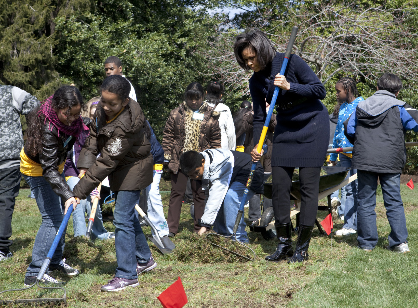 First lady Michelle Obama takes part in groundbreaking of the White House Kitchen Garden on the South Lawn of the White House of the White House in Washington, Friday, March 20, 2009, with students from Washington's Bancroft Elementary School. (AP Photo/Ron Edmonds)