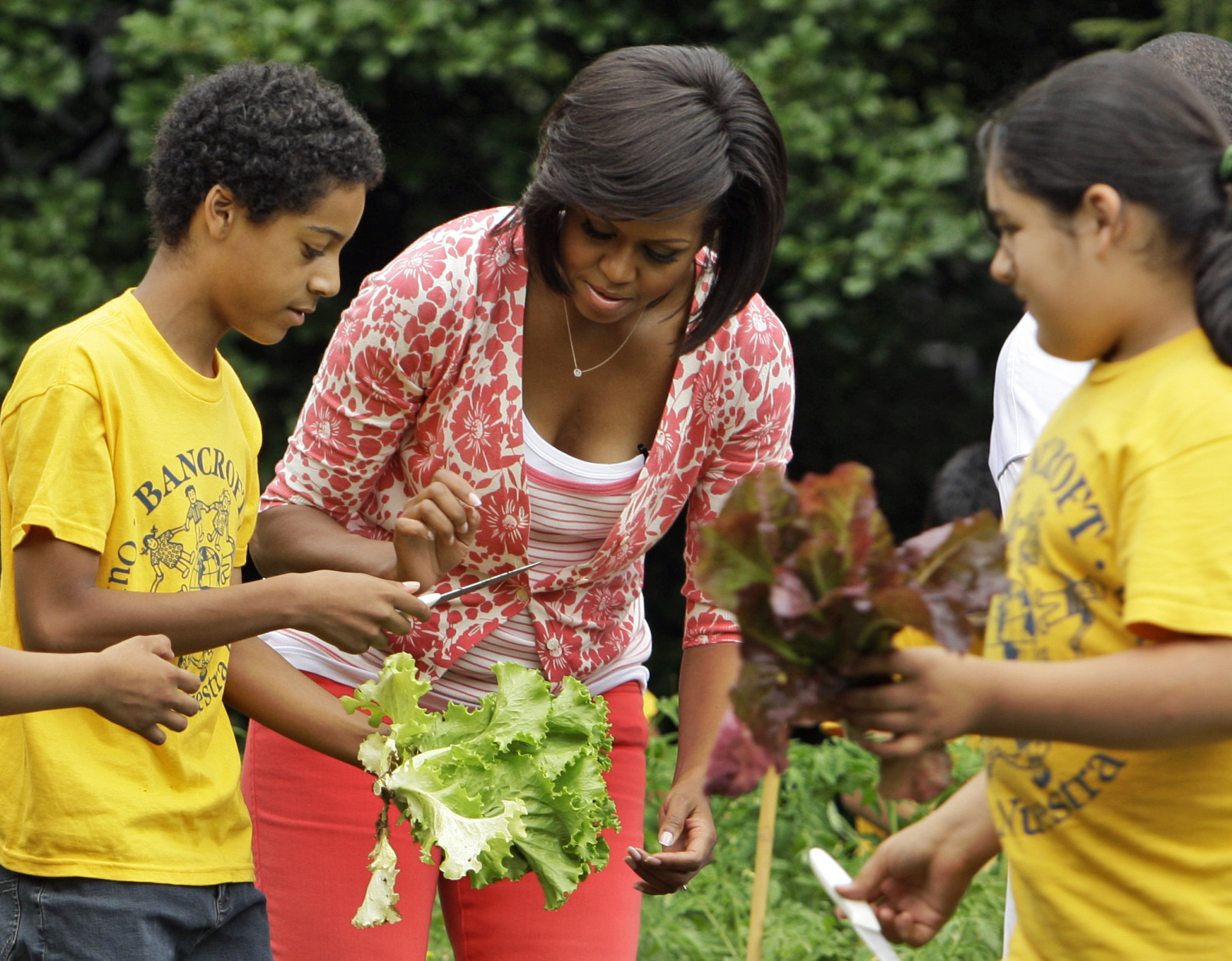 First Lady Michelle Obama works with fifth graders from Bancroft Elementary School as they harvest some of the vegetables that they planted in the garden on the South Lawn of The White House in Washington, Tuesday, June 16, 2009.(AP Photo/Alex Brandon)