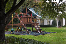 The swing set, installed for the children of President Barack Obama, Malia and Sasha, is seen with the Oval Office behind it at the White House in Washington Thursday, Oct. 15, 2009. The White House gardens will be open to the public for rare tours this weekend.  (AP Photo/Alex Brandon)