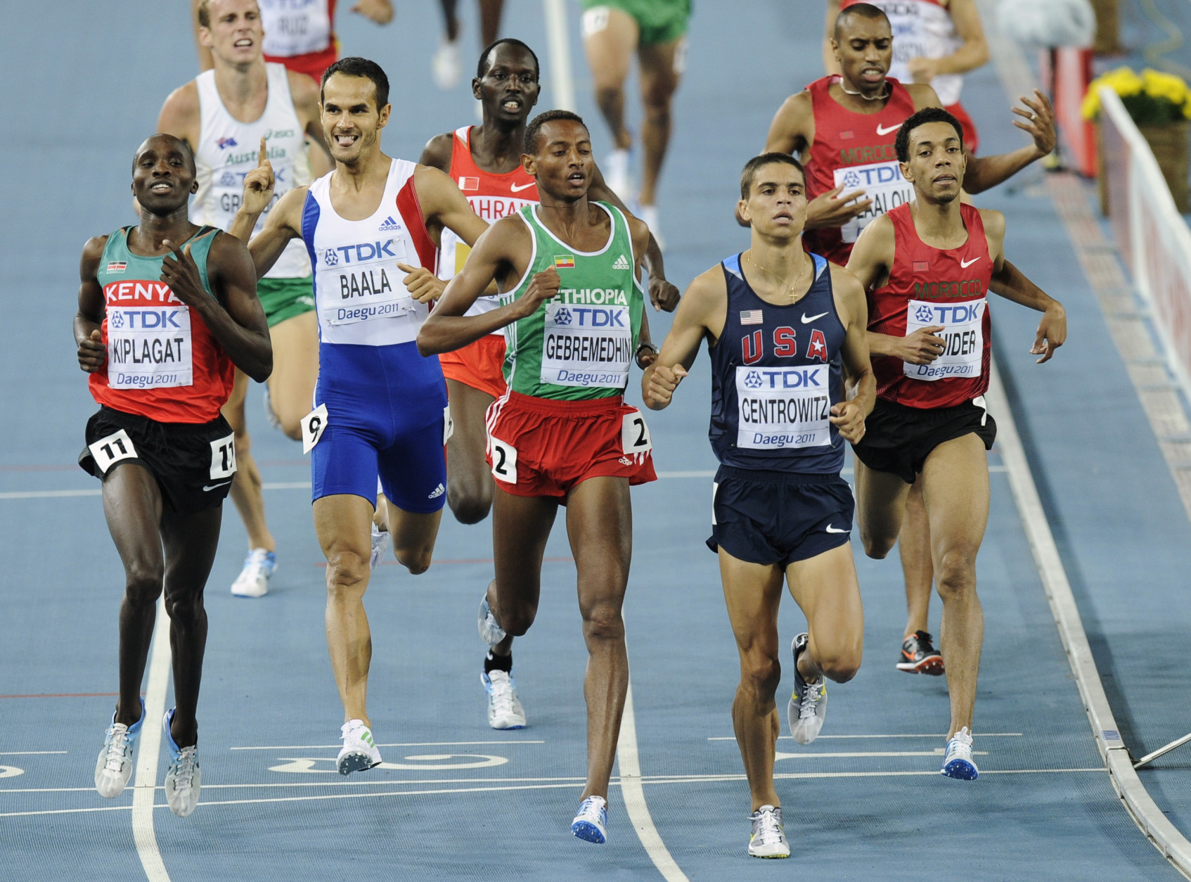 USA's Matthew Centrowitz, second from right, crosses the finish line ahead of Ethiopia's Mekonnen Gebremedhin, third from right, Kenya's Silas Kiplagat, left, France's Mehdi Baala, second from left and Morocco's Abdalaati Iguider to win a Men's 1500m semifinal at the World Athletics Championships in Daegu, South Korea, Thursday, Sept. 1, 2011. (AP Photo/Martin Meissner)