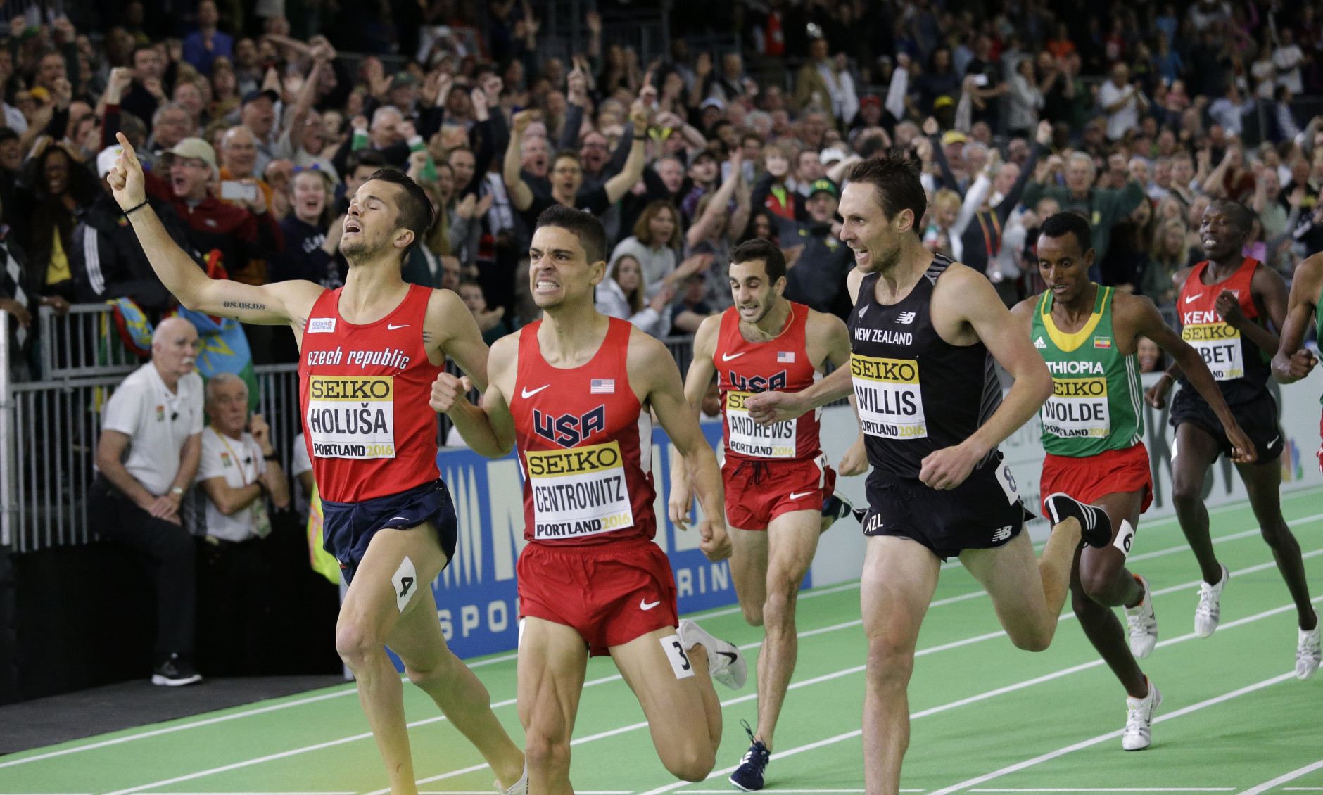 United States' Matthew Centrowitz, second from left, wins the men's 1500-meter run final during the World Indoor Athletics Championships, Sunday, March 20, 2016, in Portland, Ore. Czech Republic's Jakub Holusa, left, finished second, and New Zealand's Nicholas Willis, right, finished third. (AP Photo/Elaine Thompson)