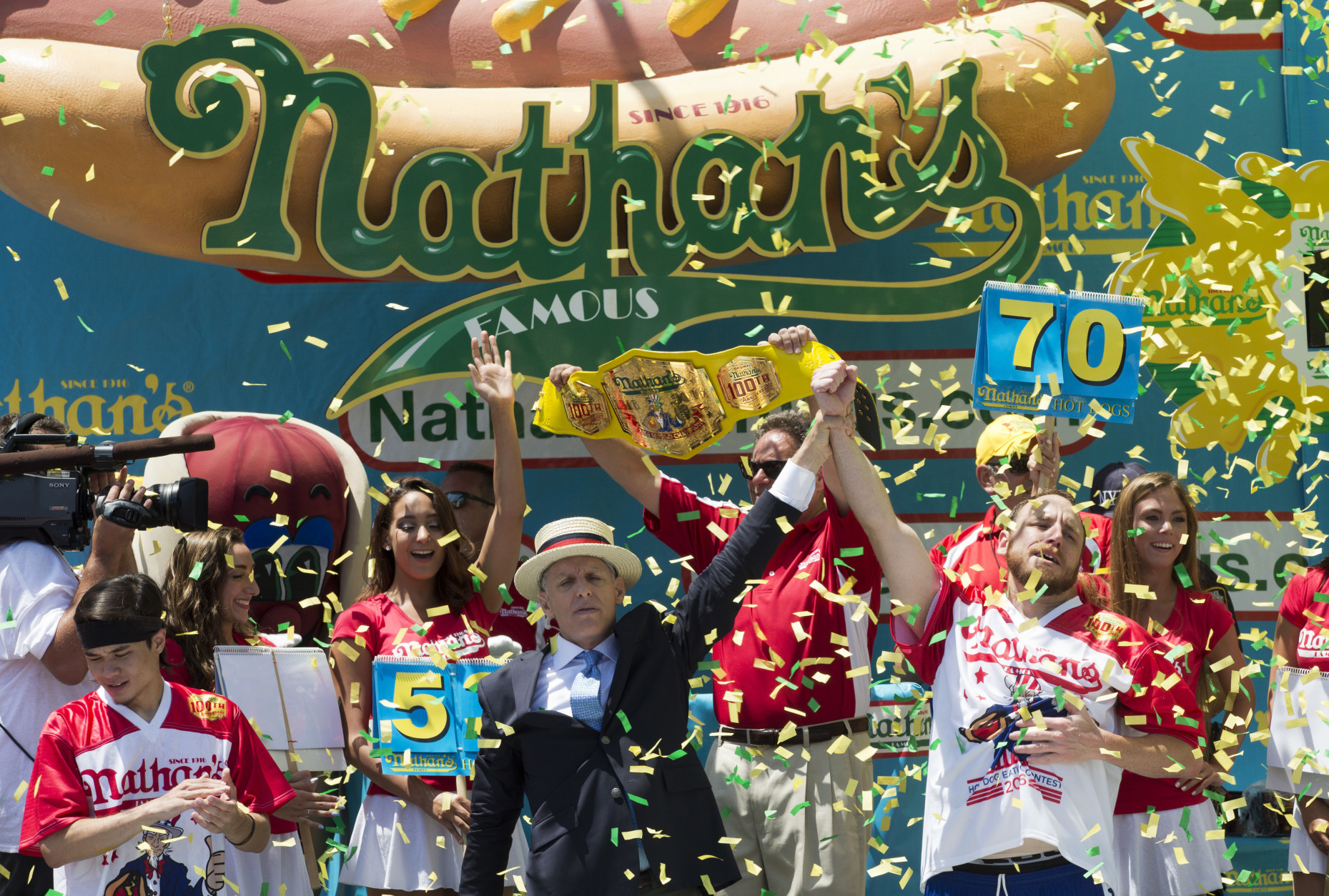 Joey Chestnut, right, is declared Nathan's Famous Fourth of July International Hot Dog Eating Contest men's competition winner, Monday, July 4, 2016, in New York. Chestnut came in first eating 70 hot dogs and buns in 10 minutes. Matt Stonie came in second eating 53 hot dogs and buns in 10 minutes. (AP Photo/Mary Altaffer)