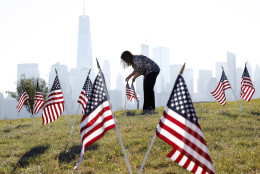 Yalenny Vargas arranges flags for the Fourth Of July celebrations at Liberty State Park on Monday, July 4, 2016, in Jersey City, N.J. (AP Photo/Mel Evans)