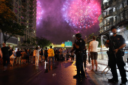 New York City counterterrorism police officers watch over spectators watching the Fourth of July fireworks, Monday, July 4, 2016, along the East River on the FDR Drive in New York. (AP Photo/Adam Hunger)