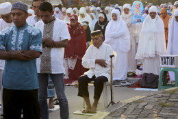 Indonesian Muslim perform an Eid al-Fitr prayer to mark the end of the holy fasting month of Ramadan at Sunda Kelapa port in Jakarta, Indonesia, Wednesday, July 6, 2016. (AP Photo/Tatan Syuflana)