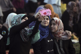 Palestinian Muslim women take their selfie photograph as they attend the Eid al-Fitr prayer marking the end of the holy fasting month of Ramadan in Gaza City, Wednesday, July 6, 2016. (AP Photo/ Khalil Hamra)