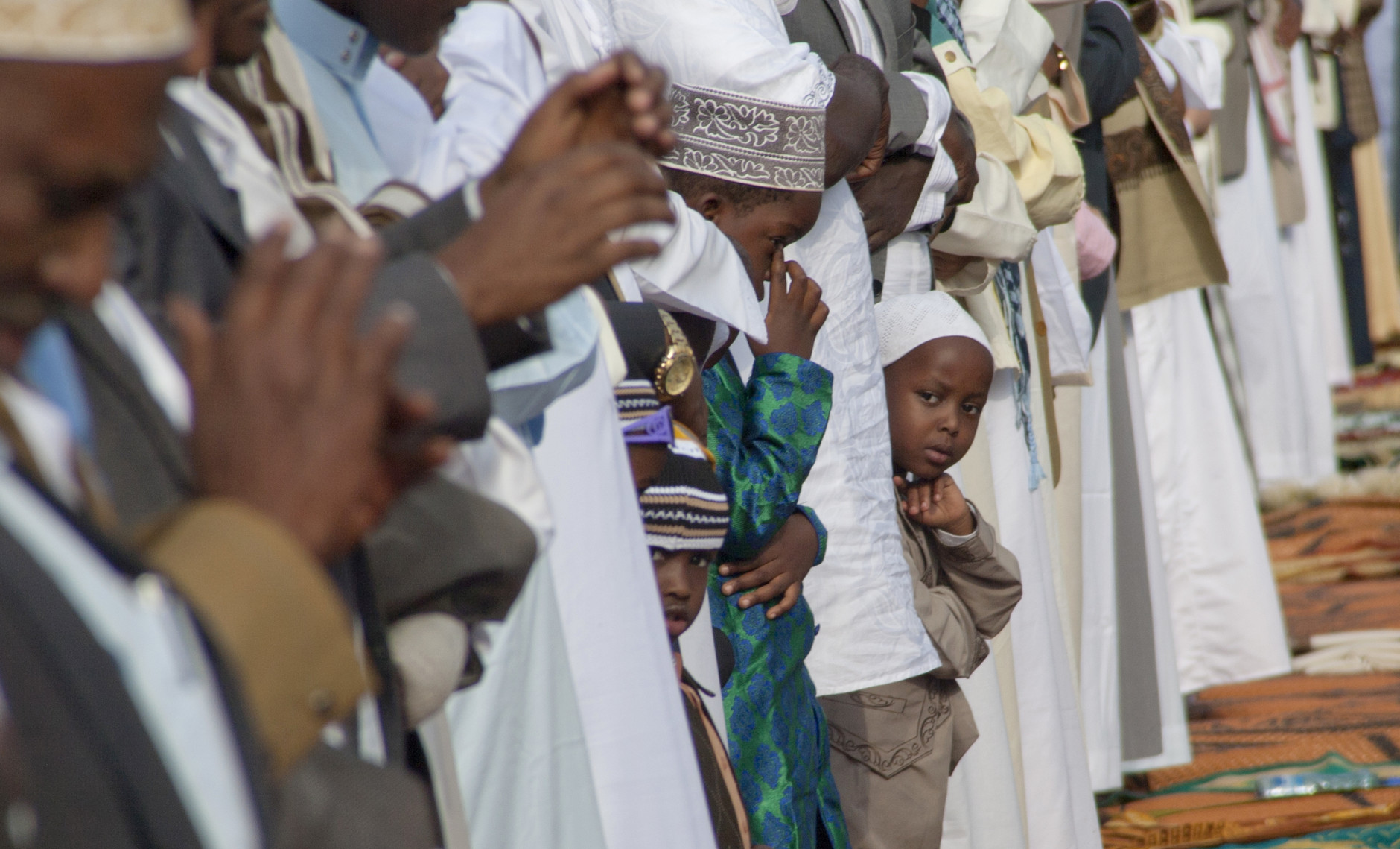Kenyan Muslim boys join in prayers during the Eid al-Fitr on the open ground as Muslims around the world celebrate the end of the holy month of Ramadan in Nairobi, Kenya, Wednesday, July 6, 2016. (AP Photo/ Sayyid Abdul Azim)