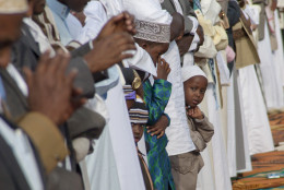 Kenyan Muslim boys join in prayers during the Eid al-Fitr on the open ground as Muslims around the world celebrate the end of the holy month of Ramadan in Nairobi, Kenya, Wednesday, July 6, 2016. (AP Photo/ Sayyid Abdul Azim)