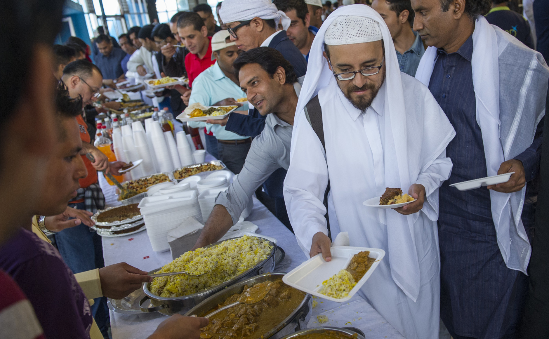 Muslims receive food after Eid al-Fitr prayers which mark the end of the holy fasting month of Ramadan, at a gym in Mexico City, Wednesday, July 6, 2016. According to the Washington-based Pew Forum on Religion and Public Life, today there are approximately 110,000 Muslims living in Mexico. (AP Photo/Nick Wagner)