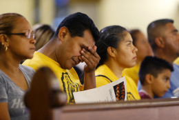 A worshiper wipes his eyes during a "United To Heal Prayer Vigil" at Cathedral Guadalupe, in honor of the Dallas police officers who were slain Thursday, in Dallas, Friday, July 8, 2016. A peaceful protest in Dallas over the recent videotaped shootings of black men by police turned violent Thursday night as gunman Micah Johnson shot at officers, killing five and injuring seven, as well as two civilians. (AP Photo/Gerald Herbert)