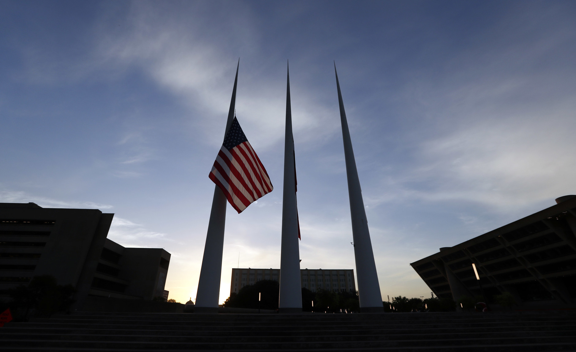Flags fly at half-staff over Dallas Cityhall , Saturday, July 9, 2016, in Dallas. Five police officers are dead and several injured following a shooting in downtown Dallas Thursday night. (AP Photo/Eric Gay)