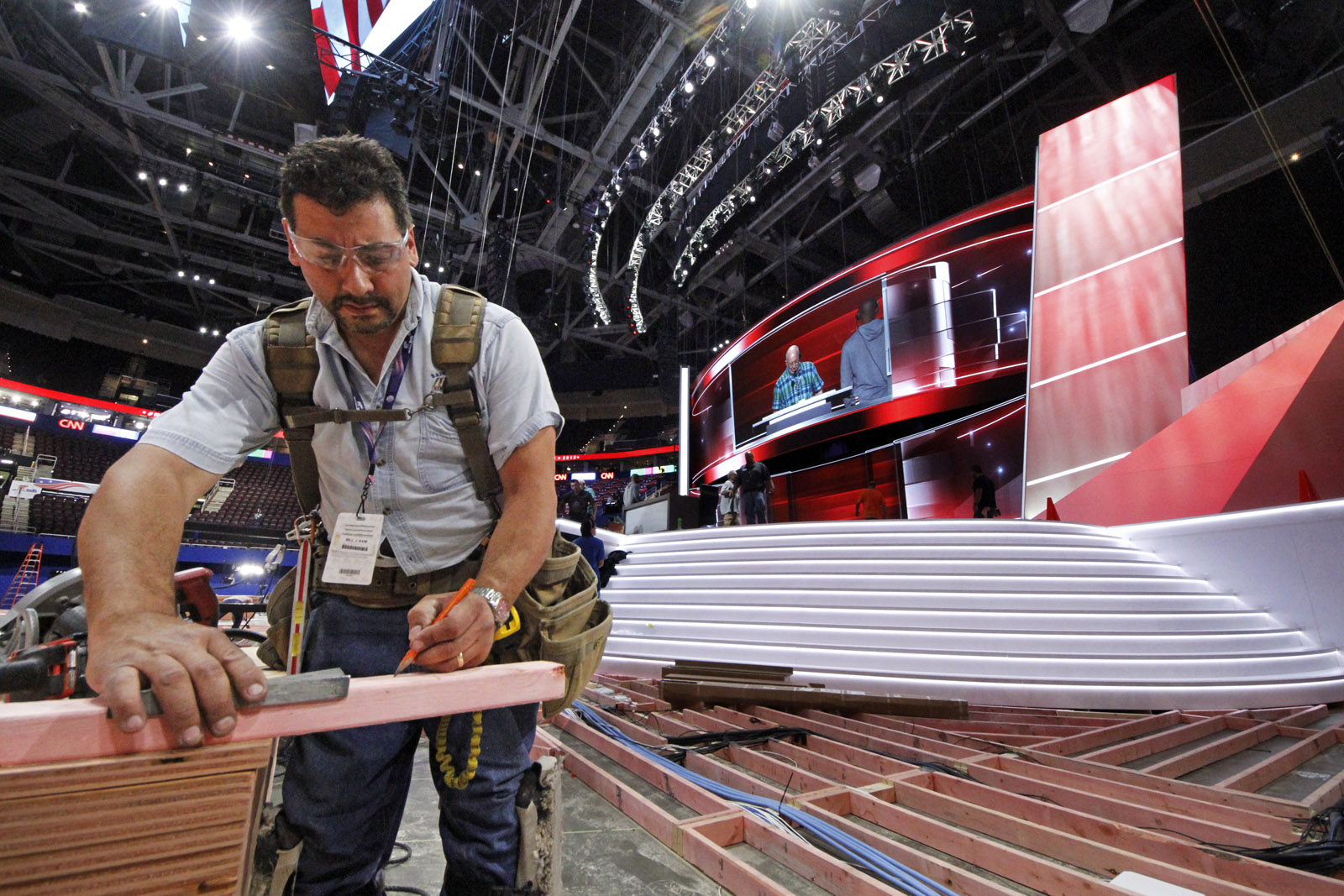 Carpenter Bill Kaim of Cleveland, works on the convention floor at the Quicken Loans Arena in downtown Cleveland, Ohio, in preparation for the upcoming Republican National Convention Wednesday, July 13, 2016. (AP Photo/Gene J. Puskar)