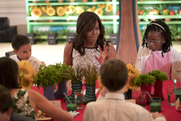 First Lady Michelle Obama, center, sits with winners of 2016 Kids' Healthy Lunchtime Challenge in the East Room of the White House in Washington, Thursday, July 14, 2016. Sitting next to Obama are Grayson Giles, left, from Guam, and Aniya Madkin, right, from Mississippi. The event is hosted by Obama and is part the Healthy Lunchtime Challenge inviting 8 to 12-years-olds across the country to create healthy, affordable, original, and delicious lunch recipes. (AP Photo/Pablo Martinez Monsivais)