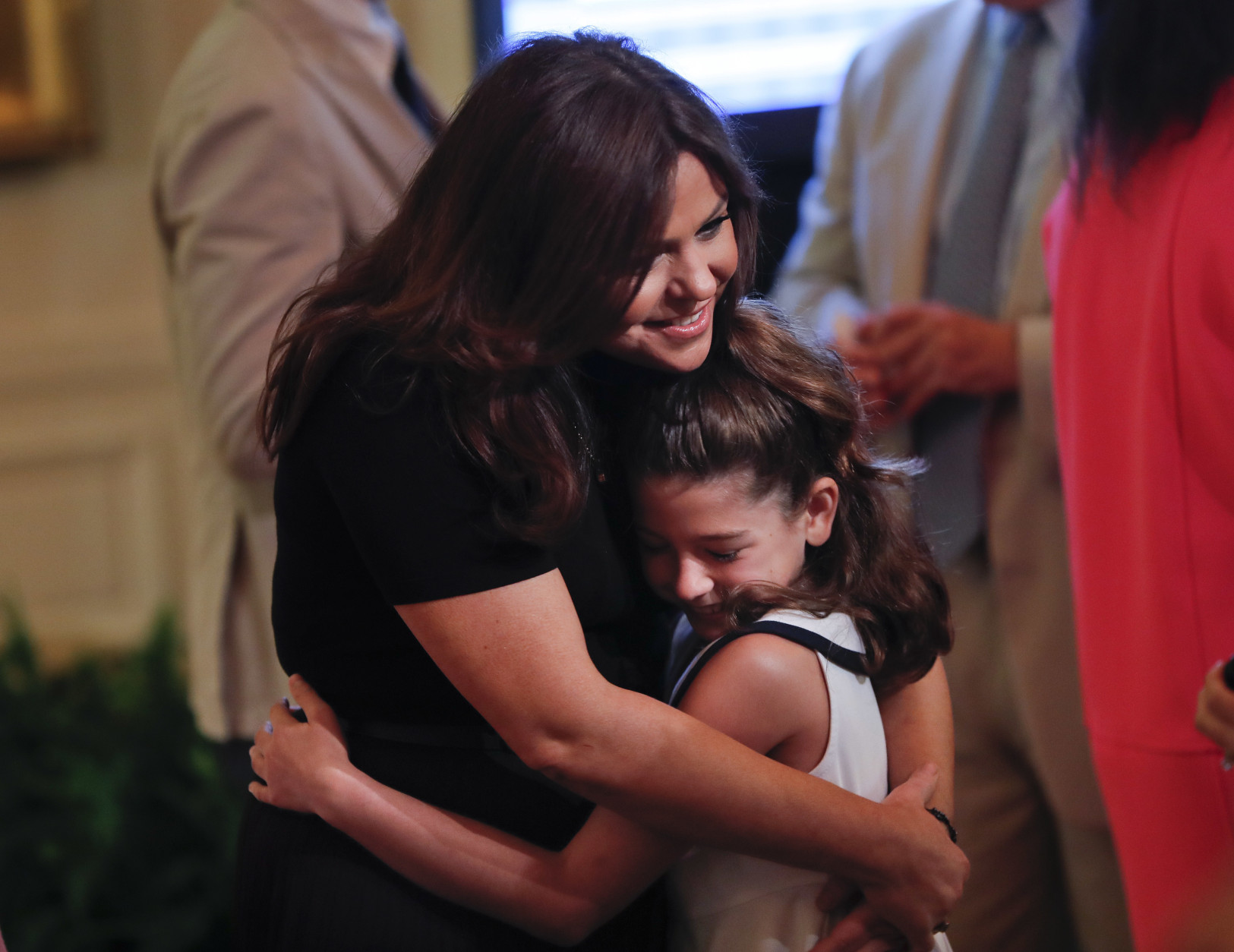 Rachael Ray, hugs Gianna Malecki, 8, from New Jersey, at the 2016 Kids' State Dinner in the East Room of the White House in Washington, Thursday, July 14, 2016. The event is hosted by first lady Michelle Obama and is part the Healthy Lunchtime Challenge inviting 8 to 12-years-olds across the country to create healthy, affordable, original, and delicious lunch recipes. (AP Photo/Pablo Martinez Monsivais)