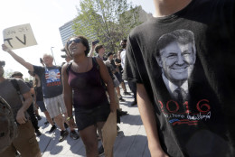 A Black Lives Matter protester shouts slogans next to next to a supporter of Republican presidential candidate Donald Trump, right, in Public Square on Tuesday, July 19, 2016, in Cleveland, during the second day of the Republican convention. (AP Photo/Mary Altaffer)