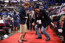 Oklahoma alternate delegate Debbie House, left, and delegate Allie Burgin dance before the start of the third day session of the Republican National Convention in Cleveland, Wednesday, July 20, 2016. (AP Photo/Matt Rourke)