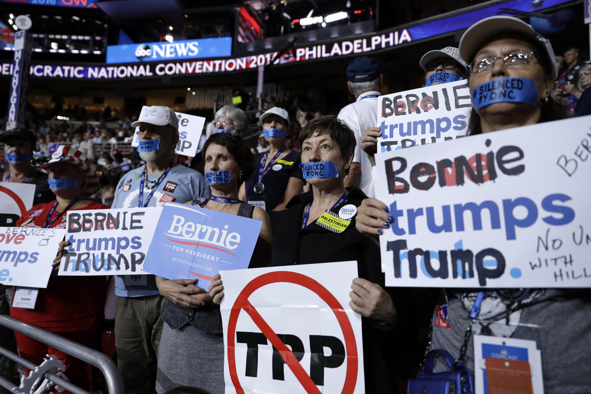 Michigan delegates wear tape covering their mouths during the first day of the Democratic National Convention in Philadelphia , Monday, July 25, 2016. (AP Photo/John Locher)