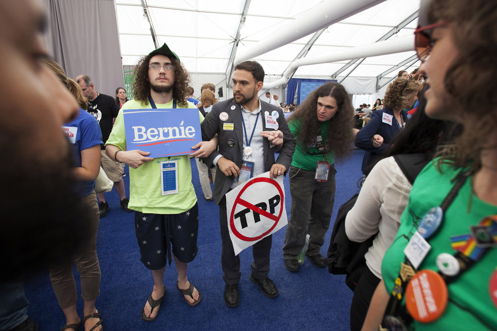 Supporters of Bernie Sanders delegate Nina Turner lock arms during protest inside the media tent on Wednesday, July 27, 2016, the third day of the Democratic National Convention in Philadelphia. They say she's being punished by the party for her support of Sanders. (AP Photo/Michael R. Sisak)