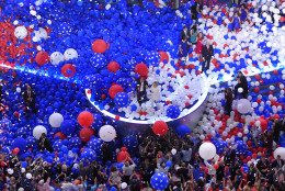Democratic vice presidential nominee Sen. Tim Kaine, D-Va., and Democratic presidential nominee Hillary Clinton waves to supporters as balloons s the balloons fall during the final day of the Democratic National Convention in Philadelphia , Friday, July 29, 2016. (AP Photo/Mark J. Terrill)