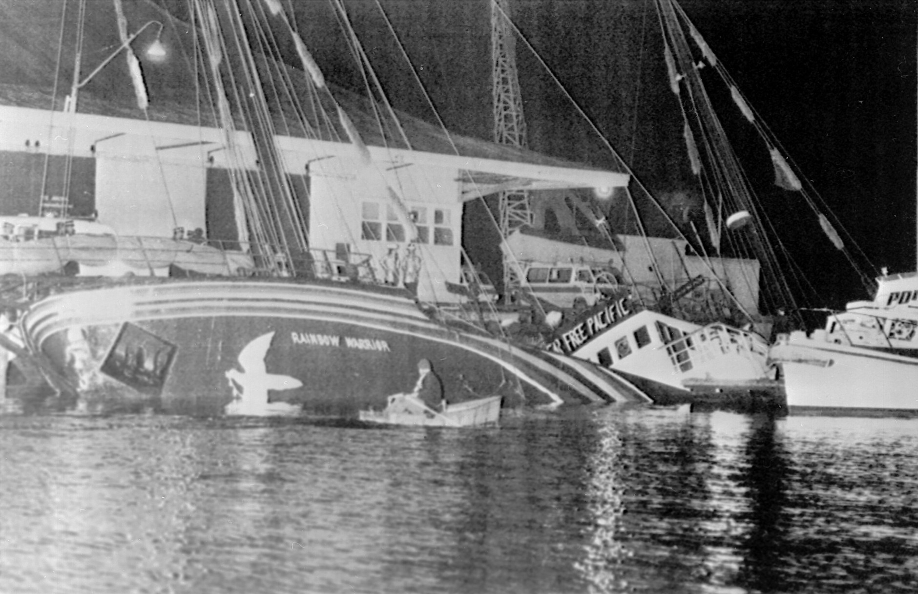 FILE - In this July 10, 1985 file photo, the Greenpeace ship Rainbow Warrior is seen after it was sank in Auckland harbor, after explosions on board.  A retired French secret service agent who says he planted the bombs 30 years ago which sank a Greenpeace ship and killed a photographer has apologized.  Jean-Luc Kister told Television New Zealand Sunday, Sept. 6, 2015, that he and his colleagues never meant to kill anybody when they attached two bombs to the Rainbow Warrior on July 10, 1985, while the boat was moored in Auckland. (NZ Herald via AP, File) NEW ZEALAND OUT