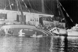 FILE - In this July 10, 1985 file photo, the Greenpeace ship Rainbow Warrior is seen after it was sank in Auckland harbor, after explosions on board.  A retired French secret service agent who says he planted the bombs 30 years ago which sank a Greenpeace ship and killed a photographer has apologized.  Jean-Luc Kister told Television New Zealand Sunday, Sept. 6, 2015, that he and his colleagues never meant to kill anybody when they attached two bombs to the Rainbow Warrior on July 10, 1985, while the boat was moored in Auckland. (NZ Herald via AP, File) NEW ZEALAND OUT