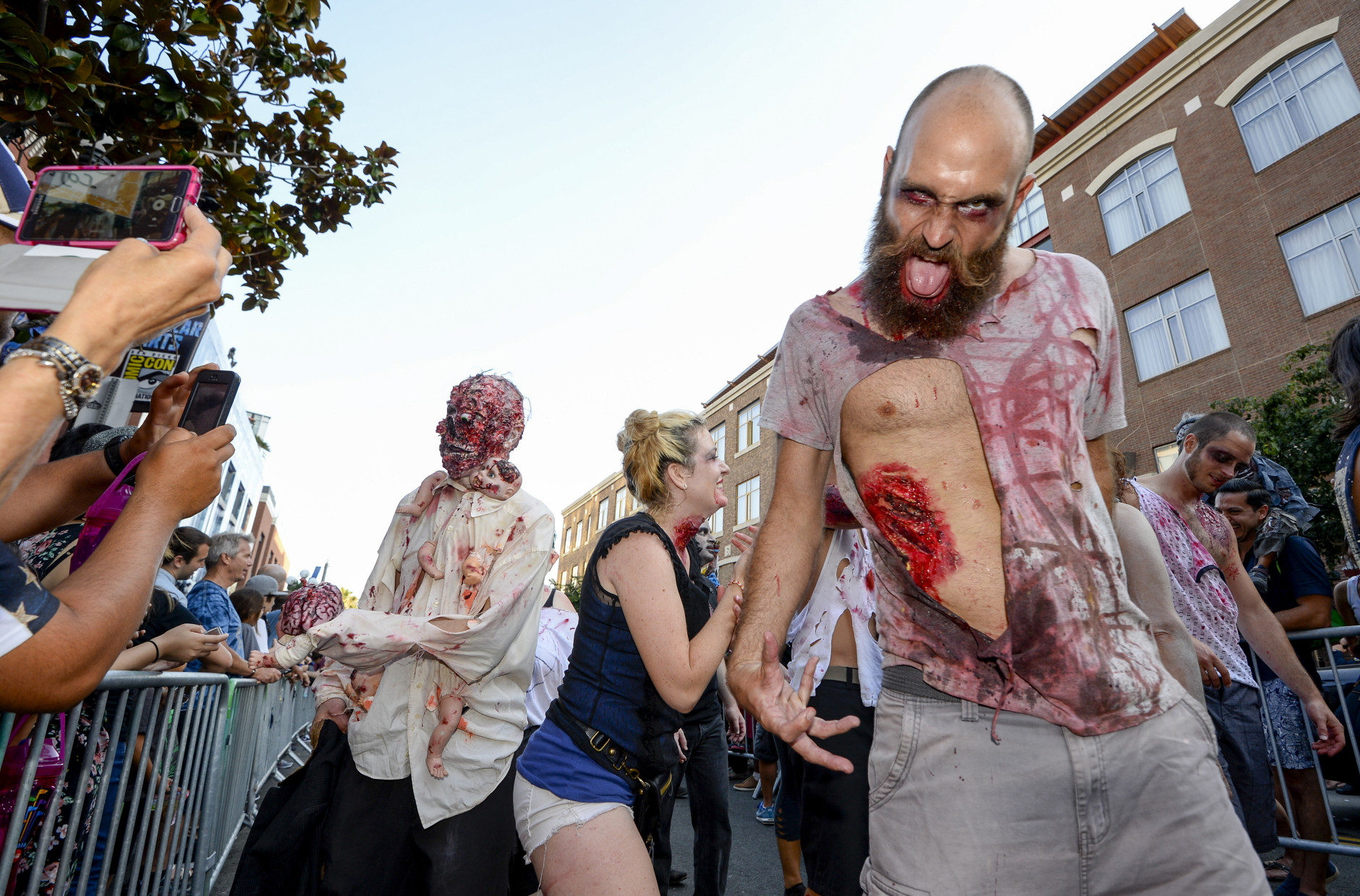 Zombies walk down Fifth Avenue as they take part in the Zombie Walk on day three of the Comic-Con International held at the San Diego Convention Center Saturday July 23, 2016 in San Diego.  (Photo by Denis Poroy/Invision/AP)