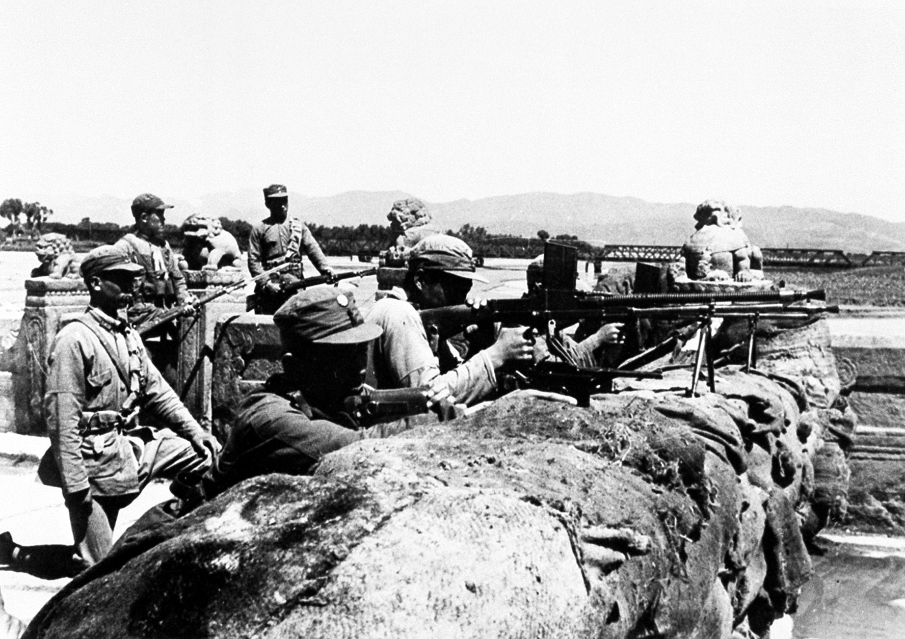 Members of the Chinese 29th Army defend the city behind a hastily constructed sandbag barricade on the Marco Polo Bridge, 14 miles southwest of Pieping, China, against Japanese attackers on July 8, 1937.  On July 7, Chinese troops fired on Japanese troops at the Marco Polo bridge, a clash between the two countries that led to the Second Sino Japanese War.  (AP Photo)