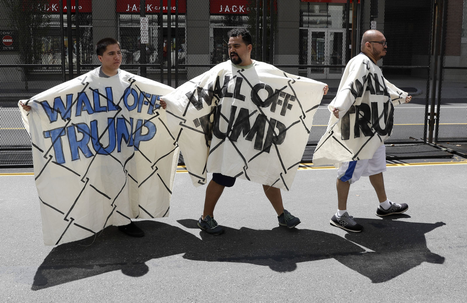Immigrant rights activists hold up a fabric wall protesting Republican presidential candidate Donald Trump, Wednesday, July 20, 2016, in Cleveland, during the third day of the Republican convention. (AP Photo/Patrick Semansky)