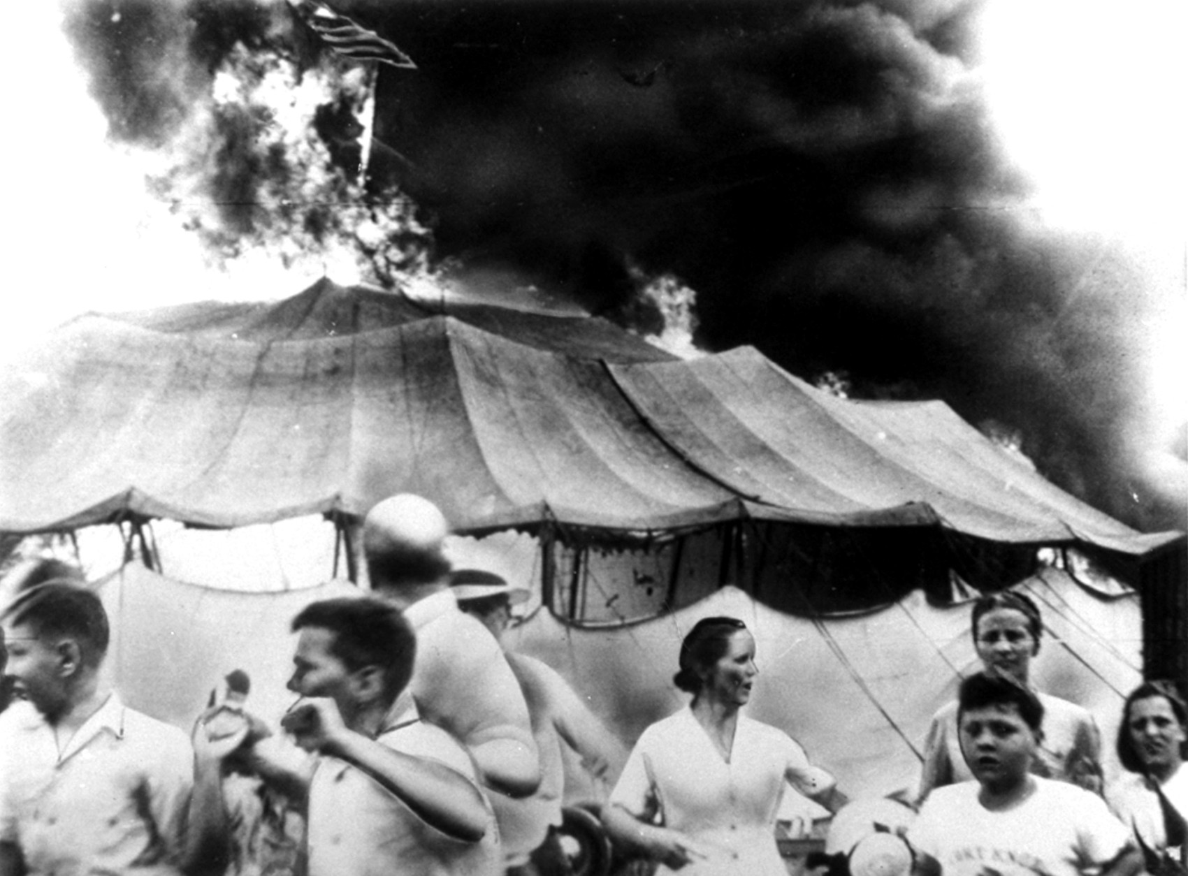 This was the scene of pandemonium at Hartford, Conn., on July 6, 1944, when a fire in which over 145 persons died, struck the tented Ringling Bros. Barnum and Bailey Circus.  On July 16, the circus folded its mammoth tent for the last time after a performance at Pittsburgh, Pa., and then appeared in 1957 in indoor arenas.  Labor troubles, bad weather, and rising costs sounded the death knell for the circus tour which thrilled millions of youngsters and grownups.  (AP Photo)
