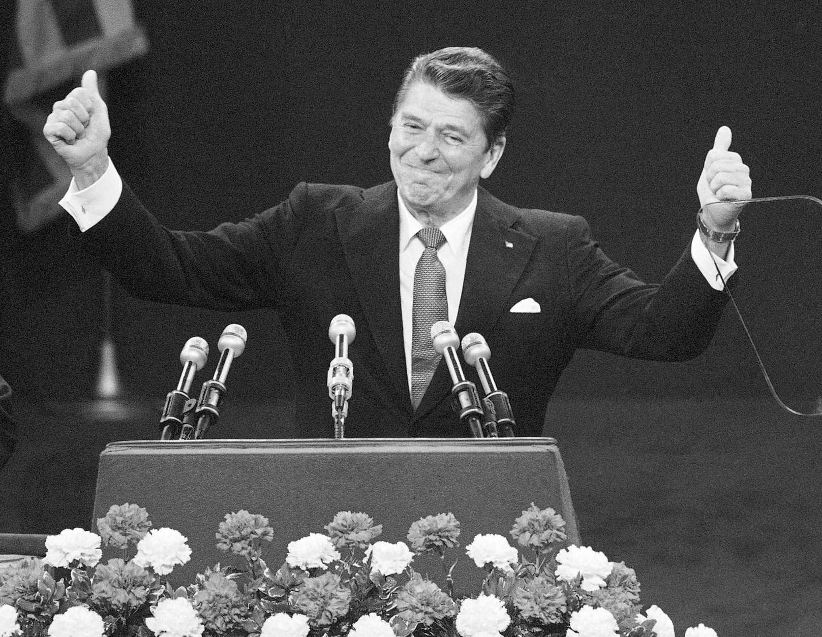 FILE - In this July 17, 1980, file photo, Republican presidential candidate Ronald Reagan stands before a cheering Republican National Convention in Detroit's Joe Louis Arena. Republicans heading to their 2012 party convention in Tampa are eager to hear an earful about the shortcomings of President Barack Obama's record, the woeful U.S. economy and the competing visions of the two presidential candidates. They aren't looking for compromise, which most Americans say is necessary to get the nation on track. The delegates hear rhetoric that is brutal, vitriolic and far from conciliatory. The Republicans want a party like in 1980 when the GOP ousted a Democratic president after one term. (AP Photo/Rusty Kennedy, File)