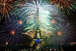 CORRECTS DAY AND YEAR - Fireworks illuminate the Eiffel Tower in Paris during Bastille Day celebrations late Tuesday, July 14, 2015. Bastille Day marks the July 14, 1789, storming of the Bastille prison by angry Paris crowds that helped spark the French Revolution. (AP Photo/Thibault Camus)