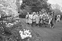 Lady Bird Johnson, left, wife of Pres. Johnson, takes a group of leaders of a "Let's Beautify America" campaign on a tour of the White House flower garden, April 28, 1965.  The group gave Mrs. Johnson a report on what some of the nation's cities are doing to make themselves more beautiful.  (AP Photo)