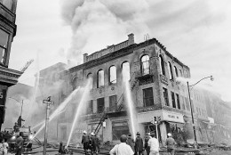 Newark firemen play steady streams of water on gutted structure at Court and Prince Streets in Newark, N.J., July 15, 1967. Three days of burning and violence have cost the New Jersey city 11 dead and hundreds wounded. (AP Photo/Marty Lederhandler)
