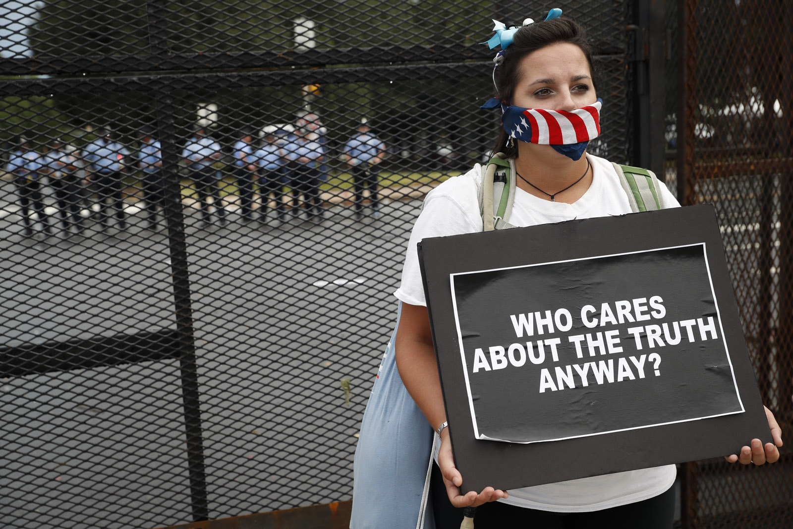 Demonstrators picket a fence as police stand guard during a protest at Franklin Delano Roosevelt park, Thursday, July 28, 2016, in Philadelphia. (AP Photo/John Minchillo)