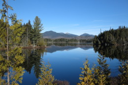 FILE - In this  Nov. 17, 2015 file photo, Adirondack High Peaks, including snow-capped Mount Marcy, the states highest summit, rear center, are reflected in Boreas Pond in North Hudson, N.Y.  A deed filed with the Essex County clerk shows New York state has purchased the 22,000-acre Boreas Ponds tract in the Adirondacks for $14.5 million. The deed was made on March 16 between the state and The Nature Conservancy and filed on April 5. A conservancy spokeswoman confirmed the purchase Thursday, April 14, 2016. (AP Photo/Mary Esch)