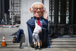 Alex Schaefer, of Los Angeles, prepares his giant Sen. Bernie Sanders, I-Vt., costume before a march during a protest in downtown on Sunday, July 24, 2016, in Philadelphia. The Democratic National Convention starts Monday in Philadelphia. (AP Photo/John Minchillo)