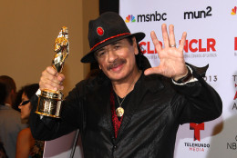 Carlos Santana poses backstage with the award for outstanding commitment to cause and community: male at the NCLR ALMA Awards at the Pasadena Civic Auditorium on Friday, Sept. 27, 2013, in Pasadena, Calif. (Photo by Paul Hebert/Invision/AP Images)