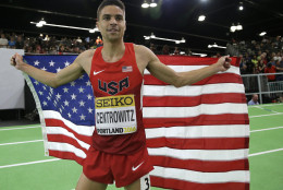 United States' Matthew Centrowitz, holds a flag after he won the men's 1500-meter run final during the World Indoor Athletics Championships, Sunday, March 20, 2016, in Portland, Ore. (AP Photo/Elaine Thompson)