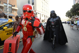 Fans dressed in Star War's themed costumes walk down the street on day three of the Comic-Con International held at the San Diego Convention Center Saturday July 23, 2016 in San Diego.  (Photo by Denis Poroy/Invision/AP)